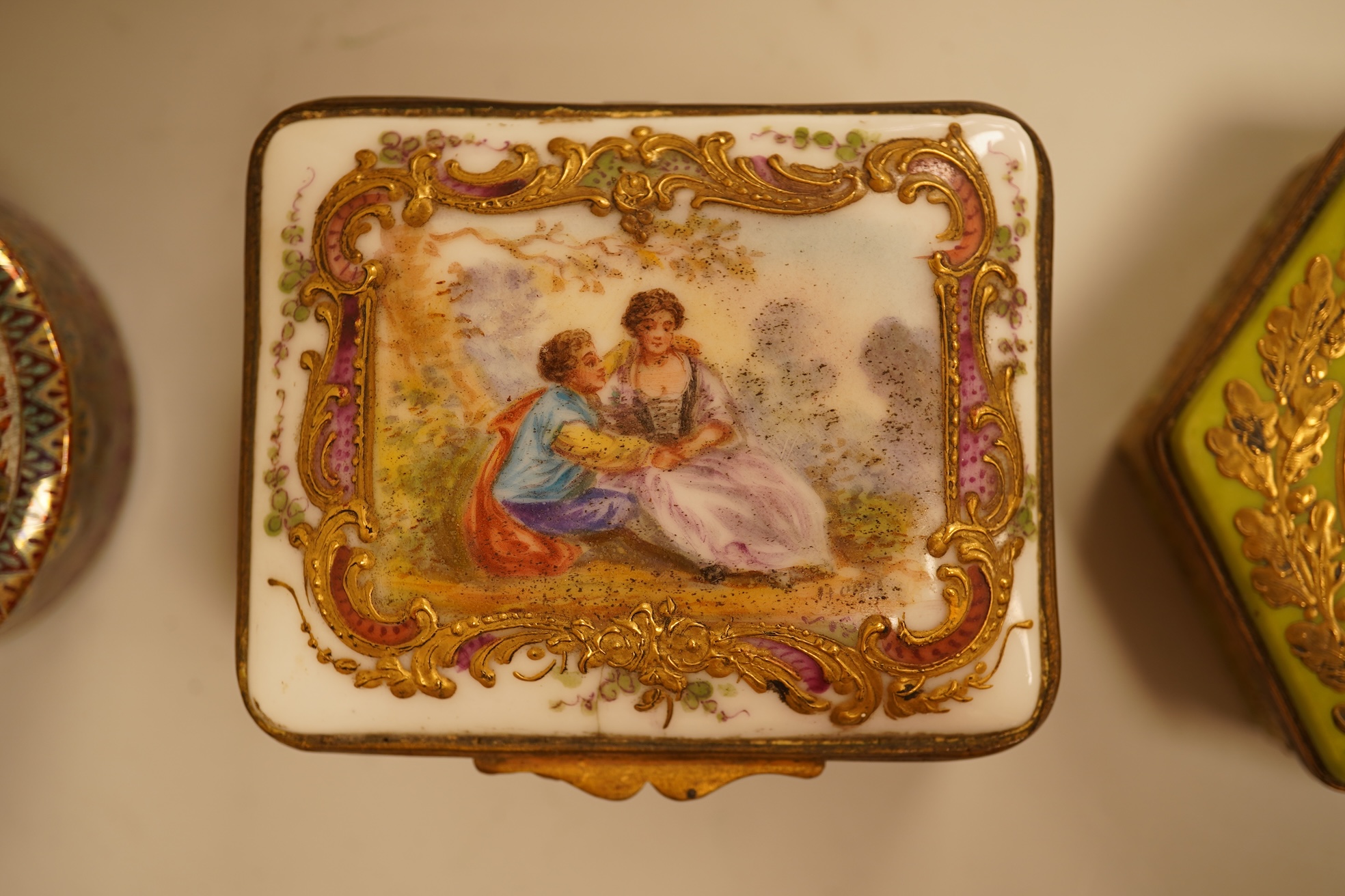 A Zsolnay lustre 'chicken' box and cover and two Sevres style porcelain boxes and covers (3) ‘chicken box’ 5cm diameter.